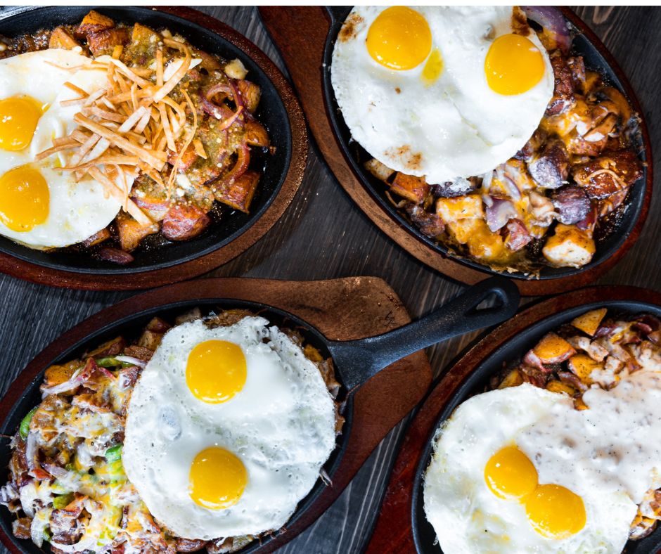 Cast iron skillet brunch flight with eggs, hash, and biscuits and gravy